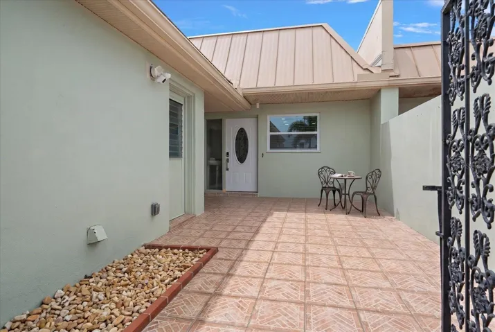 Expansive private patio, perfect for relaxing or entertaining, with convenient direct access to the attached garage.