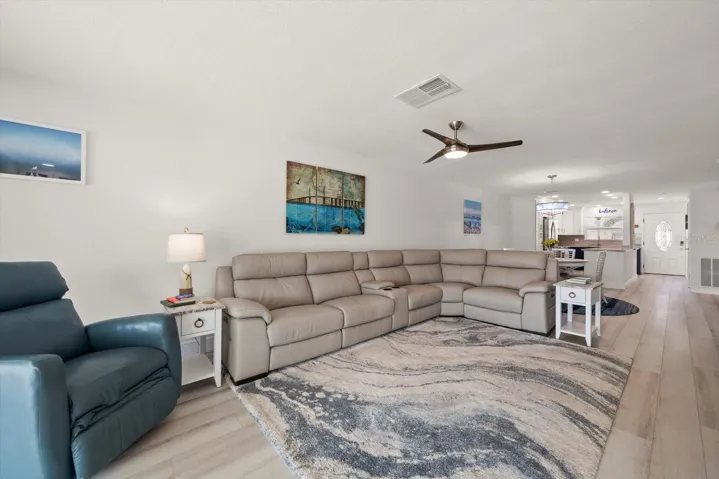 Living room opens to Dinning and Kitchen. 3 power recliners in the sectional!