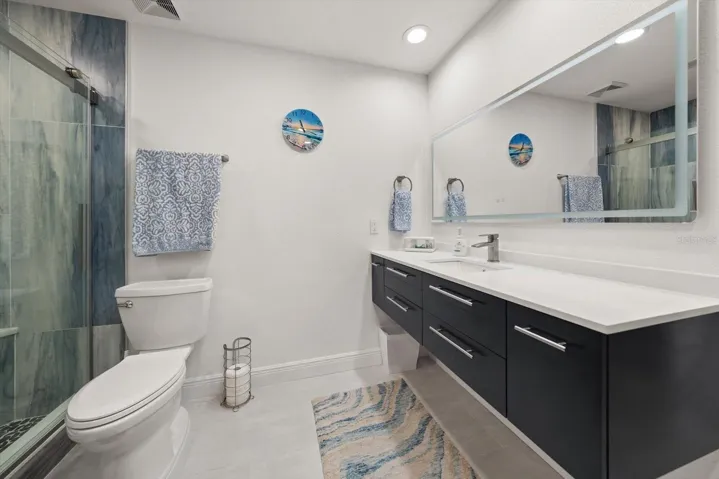 Stunning primary bathroom showcasing a contemporary floating vanity and high-end luxury accents.