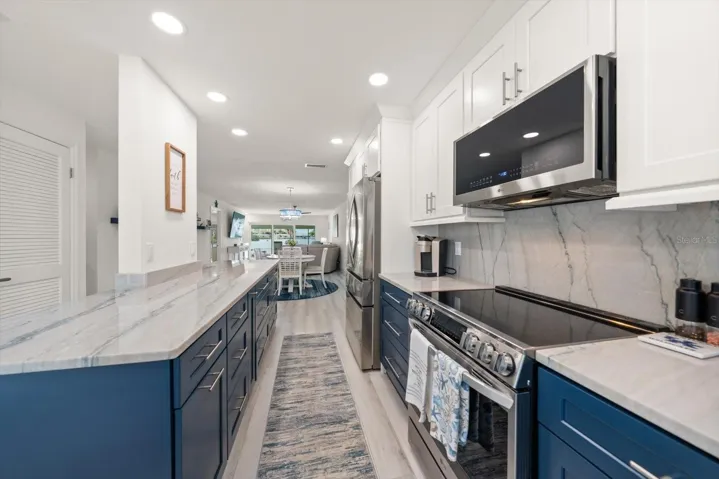Large island kitchen featuring extensive custom cabinetry that offers abundant storage space.