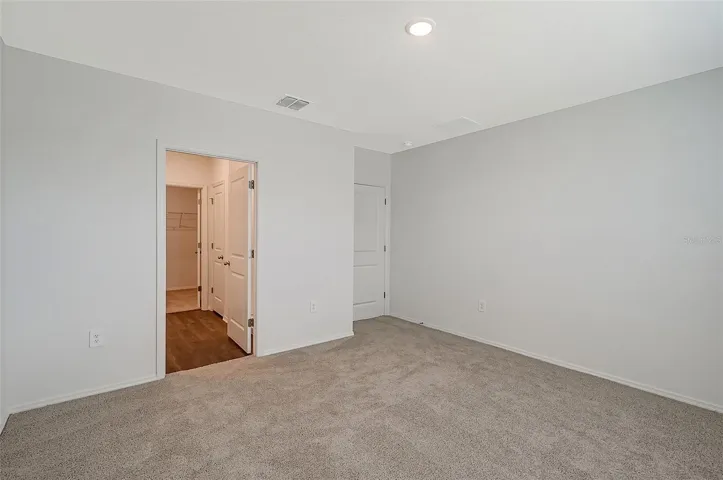Primary retreat featuring abundant natural light and a thoughtfully designed layout.