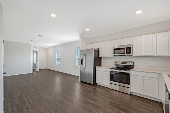 Bright and spacious great room featuring abundant natural light and an open layout designed for modern living.