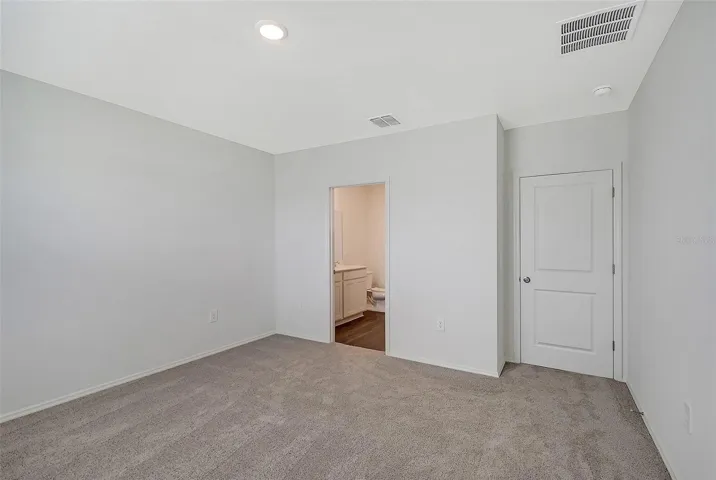 Spacious primary suite offering privacy, comfort, and room for a king-size bedroom set.
