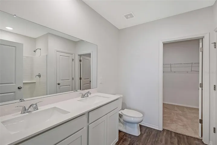 Spacious primary bath with dual vanity and a well-designed layout for everyday convenience.