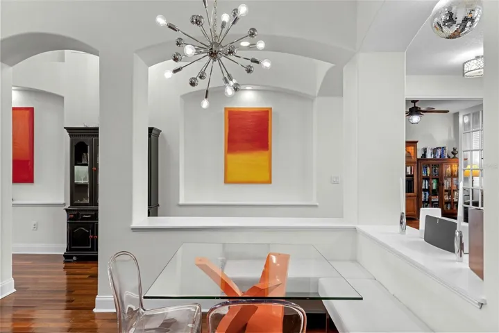 Dining area with architectural detail and updated chandelier.