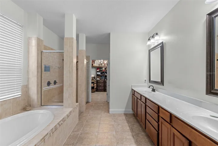 Primary bath with soaking tub, dual vanity, and walk-in shower.