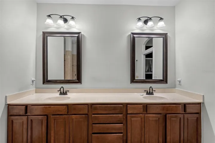 Primary bath with dual sinks and abundant vanity storage.