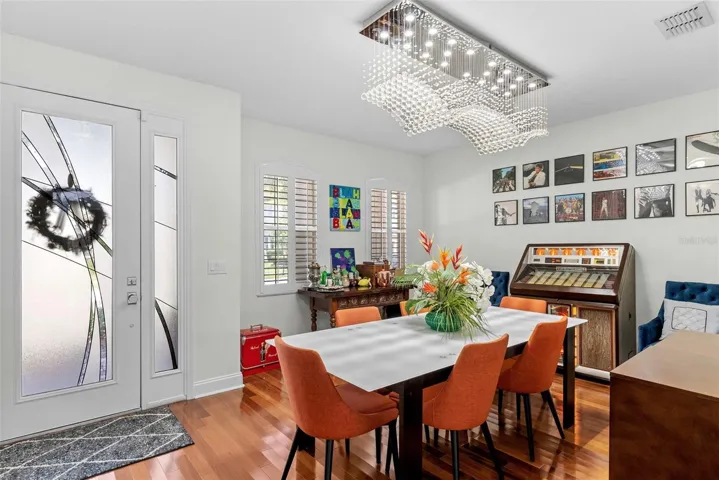 Dining room near the front entry with updated lighting.