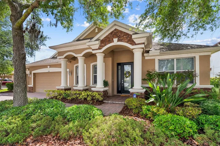 Beautiful curb appeal with mature landscaping and welcoming covered entry.