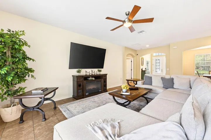 The Living Room is bright and inviting with sliding glass doors that flood the space with NATURAL LIGHT, and provide seamless access to the OUTDOOR OASIS.