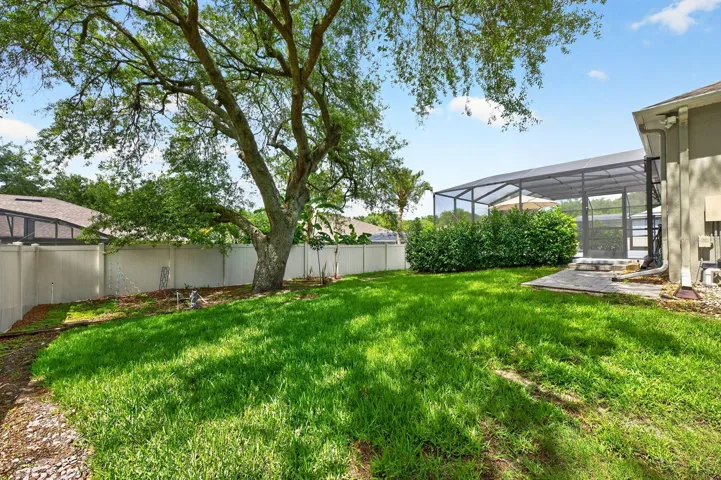 The FULLY FENCED EXPANSIVE BACKYARD offers additional space for pets, play, or gardening while maintaining privacy and security.