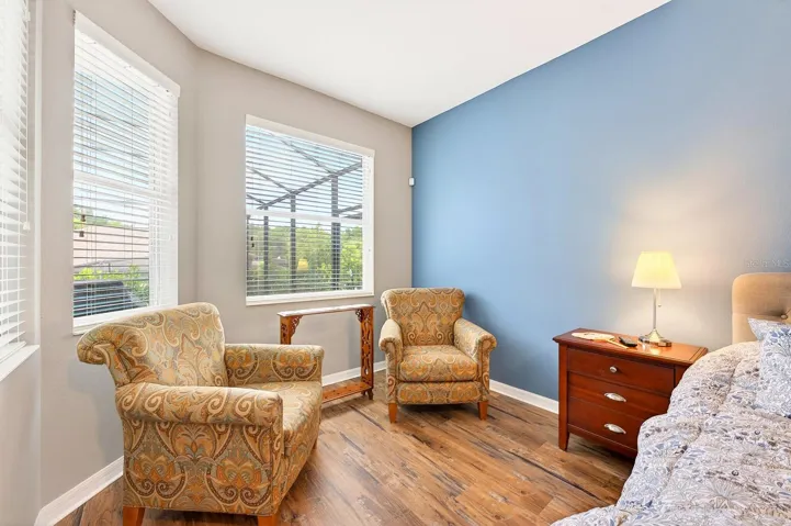 The Primary Suite sitting area has views of the backyard patio and pool.