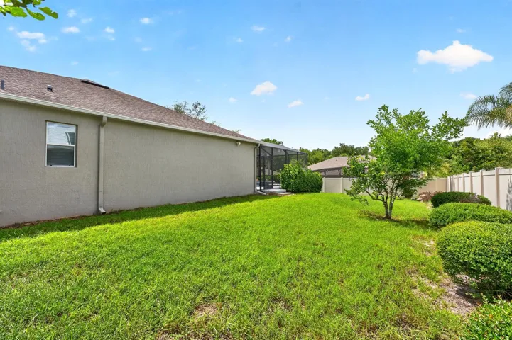 The FULLY FENCED EXPANSIVE BACKYARD offers additional space for pets, play, or gardening while maintaining privacy and security.