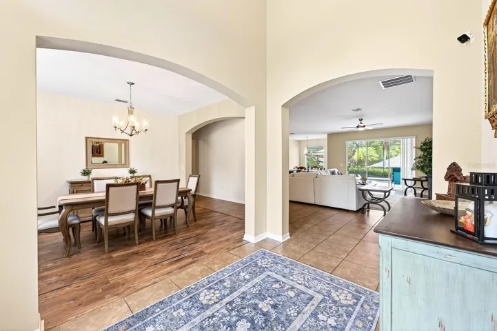 Inside, a grand foyer welcomes you into a home filled with GRACEFUL ARCHITECTURAL DETAILS, soaring 9-foot ceilings, and beautiful ceramic tile flooring throughout the main living areas.