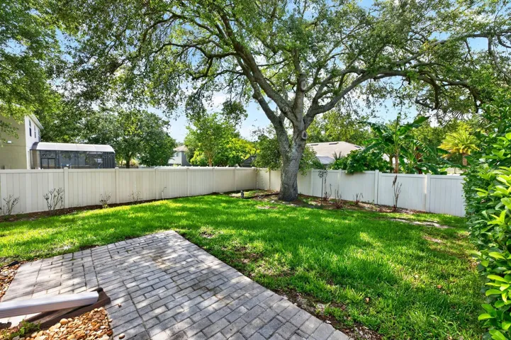 The FULLY FENCED EXPANSIVE BACKYARD offers additional space for pets, play, or gardening while maintaining privacy and security.