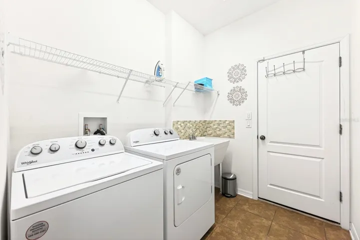 A well located Laundry Room complete with utility sink, washer and dryer, adds everyday practicality.