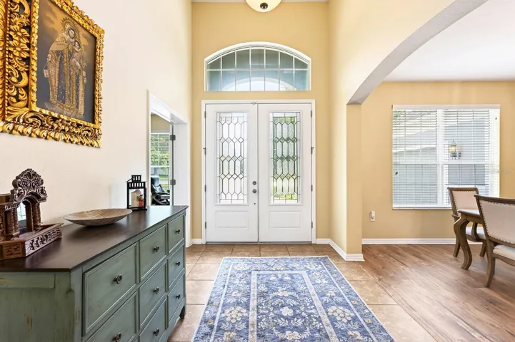 As you arrive, you'll appreciate the home's EXCEPTIONAL CURB APPEAL highlighted by lush landscaping, a brick paver driveway, and an elegant French-door entry with ETCHED GLASS ACCENTS.