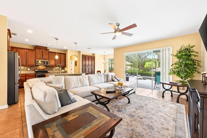 The Living Room is bright and inviting with sliding glass doors that flood the space with NATURAL LIGHT, and provide seamless access to the OUTDOOR OASIS.