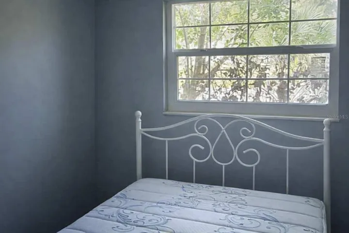 Comfortable secondary bedroom with serene natural light and flexible layout options.