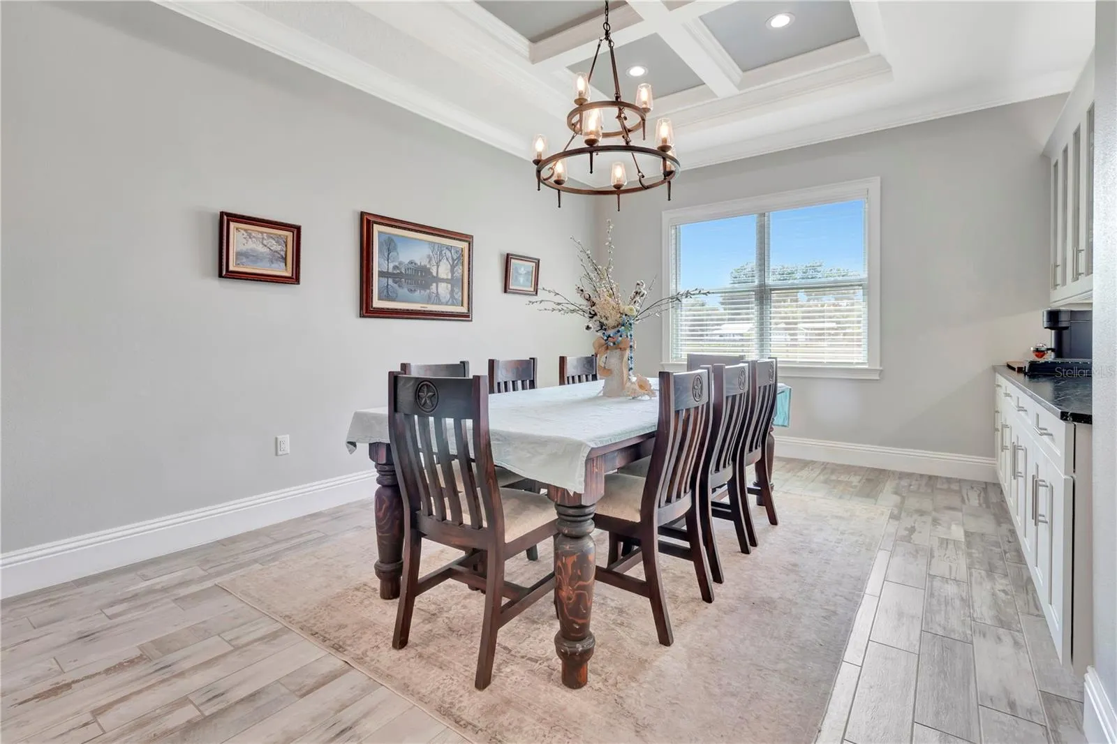Dining Room with Crown Molding and Beautiful Lighting