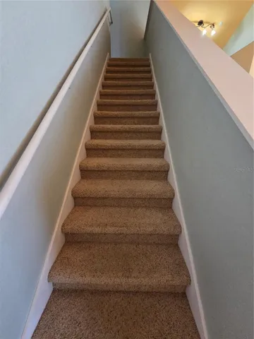 carpeted stairs and upstairs bedrooms