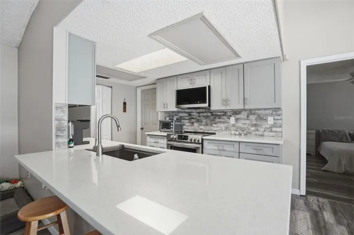 Remodeled kitchen with Large Quartz Breakfast Bar for extra seating!