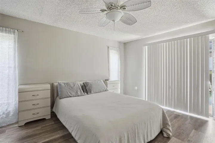 Master bedroom. New luxury vinyl floors, glass sliders to the pool.