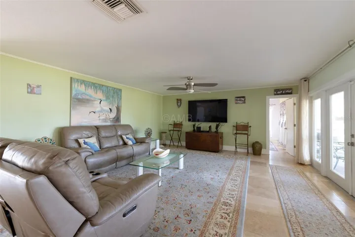 Living room has incredible view to lanai and waterway!