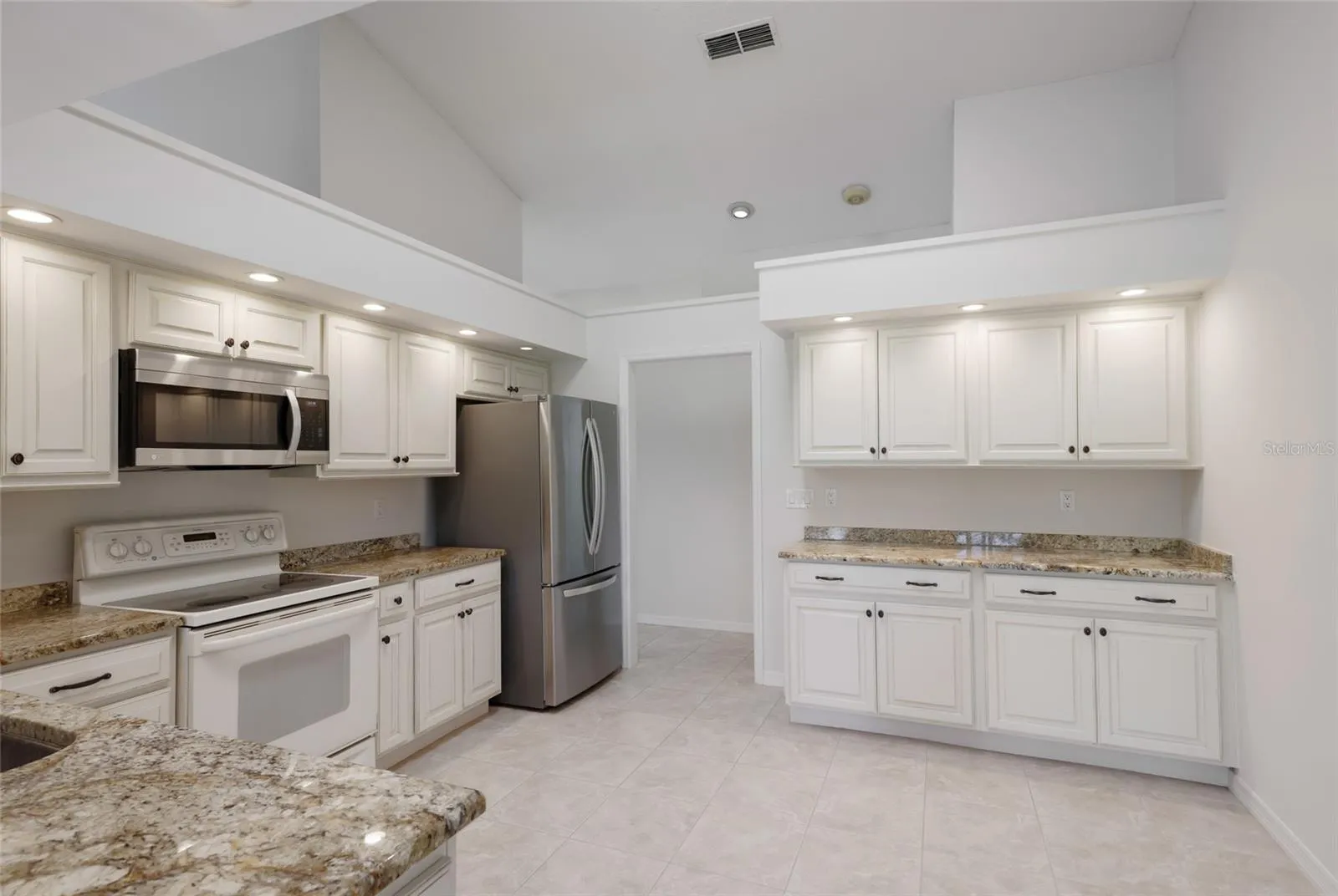 Updated kitchen with custom wood cabinetry. Cathedral ceilings and skylights throughout the house.
