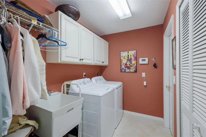 Laundry room with utility sink with door leading to the garage.