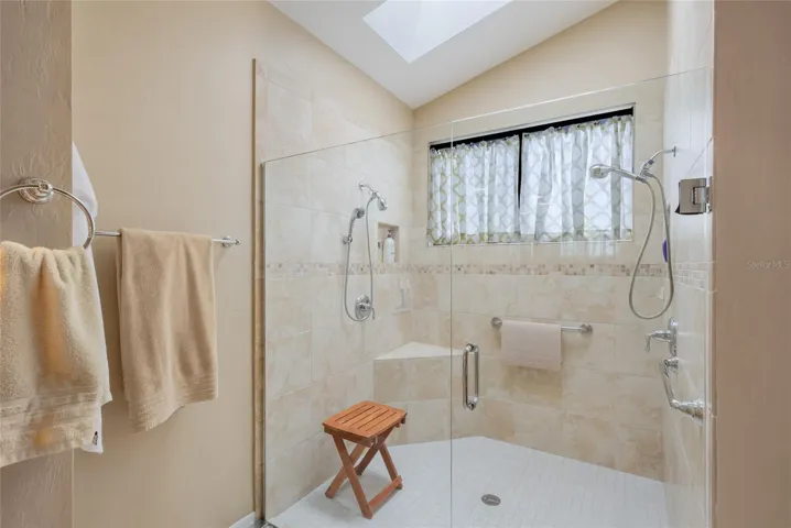 Updated walk-in shower with skylight.