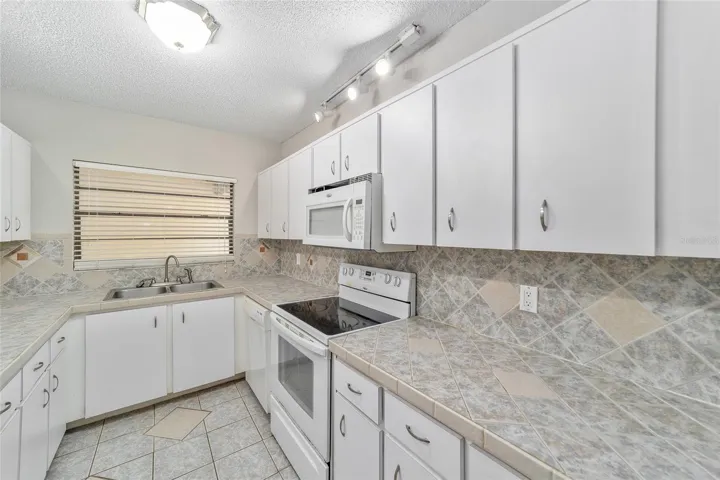 Kitchen with Ceramic counters lots of cabinets