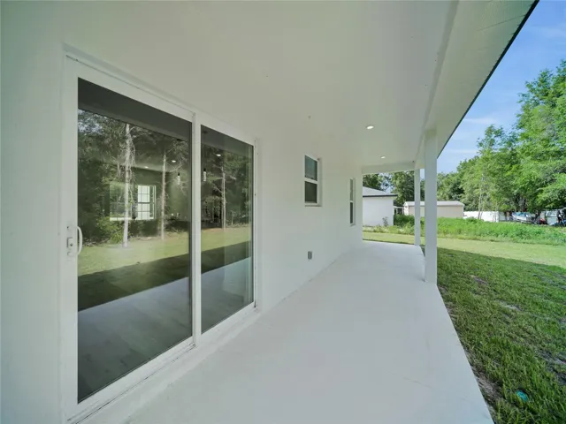 Covered rear lanai overlooking the backyard