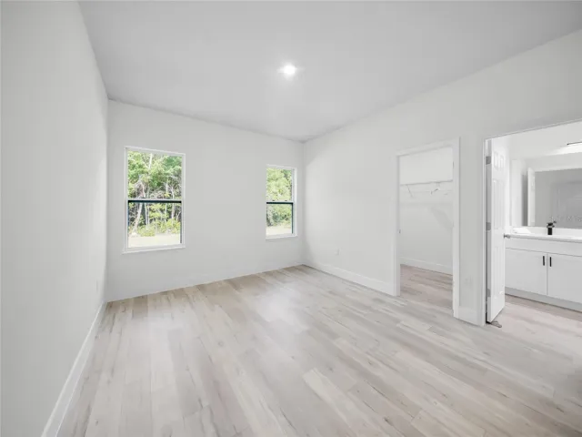 Spacious primary bedroom with natural light
