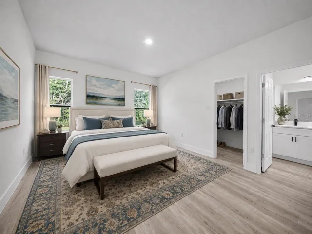 Primary suite with generous layout and direct access to the spa-inspired bath - virtually staged