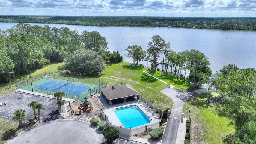 Aerial View of tennis court and communtiy pool with lake