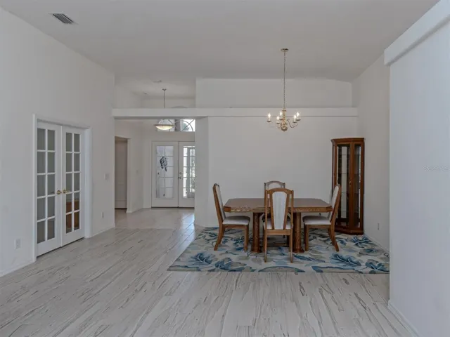 The screened in front entrance leads to the beautiful double glass entry doors