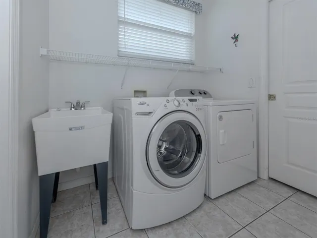 In the laundry room located off the kitchen you will find a double storage cabinet, cabinetry and utility sink