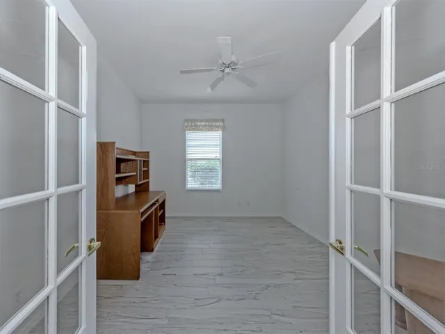 This large den is located in the heart of the home and includes double glass doors and can double as a craft room, TV room, or overflow space for guests.