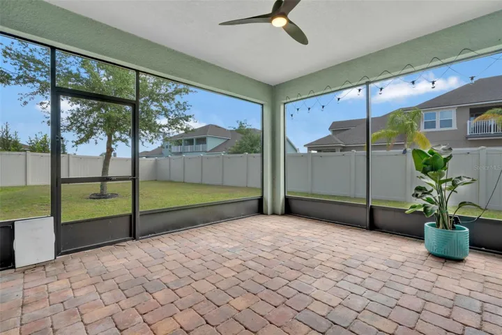 Screened Patio with Pavers overlooking large back yard.