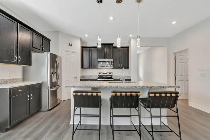 Light and bright gourmet kitchen with center island.