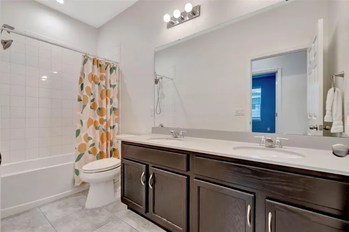 Spacious secondary bath with dual sinks.