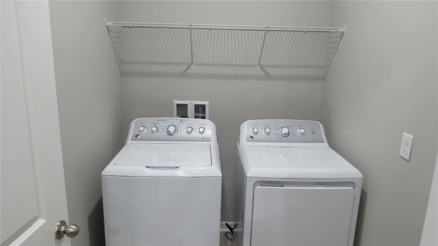 Spacious laundry room with washer and dryer