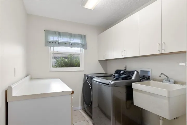 Large laundry room with access to two car garage