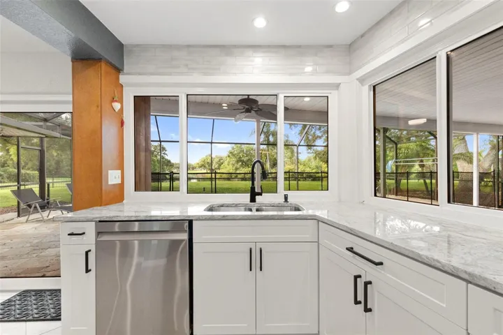 Kitchen access to pool area and screened in patio