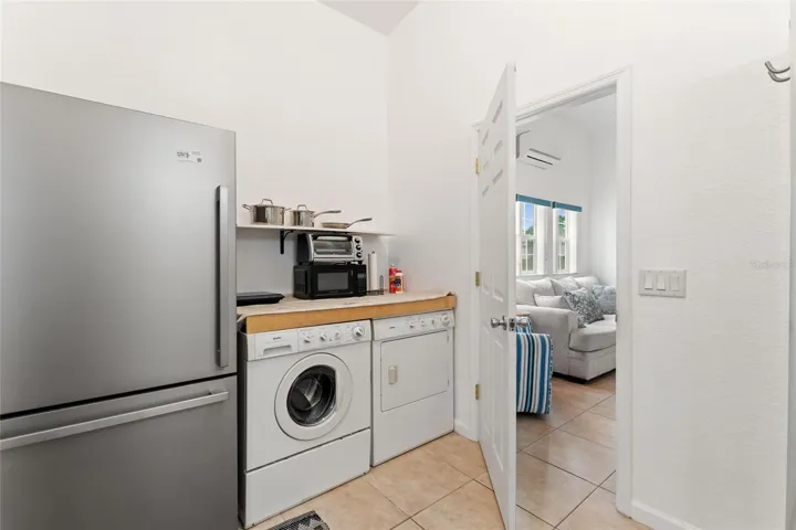Laundry Area with refrigerator & microwave