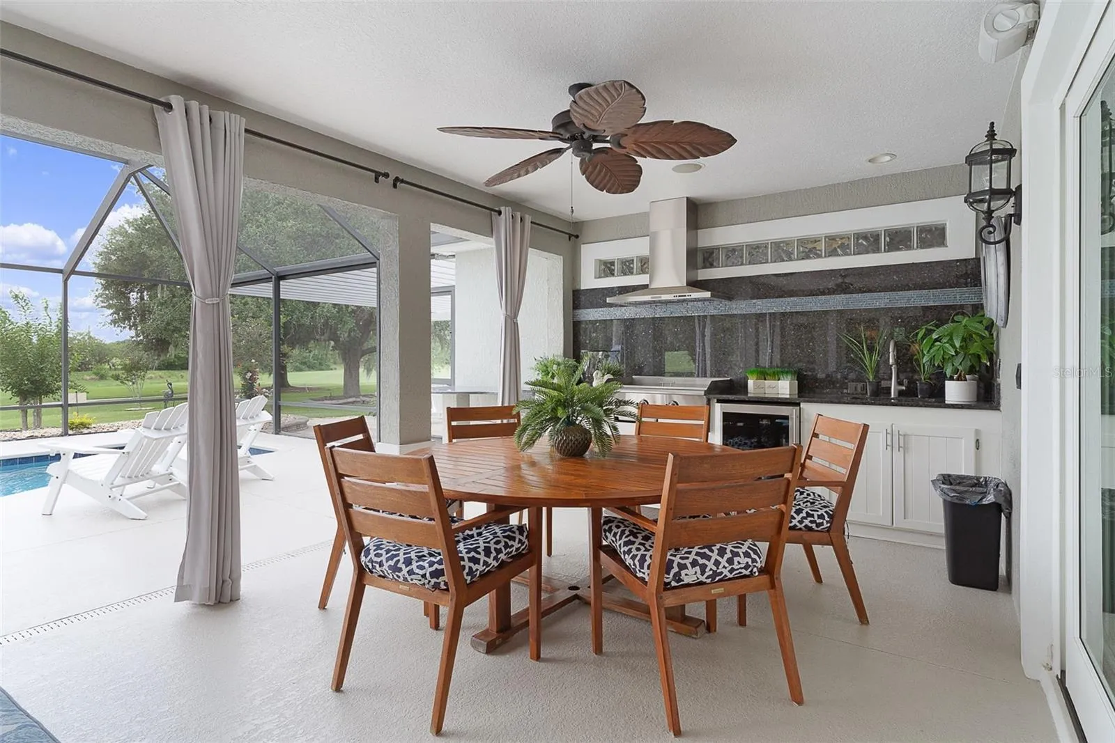 The outside dining area with a beautful oversized outdoor kitchen