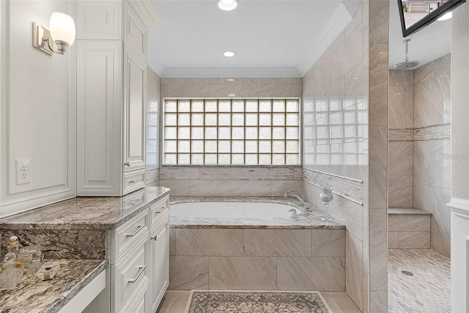 A great view of the soaking tub and the beautiful Roman shower