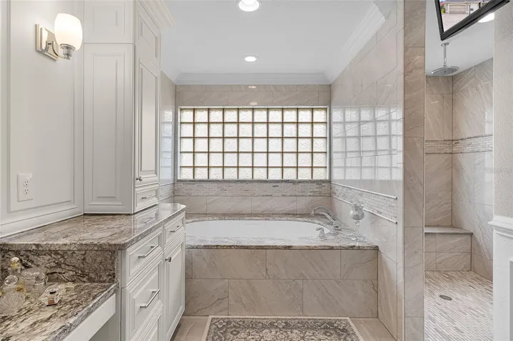 A great view of the soaking tub and the beautiful Roman shower
