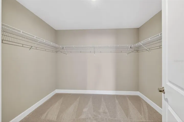 One of two primary walk-in closets